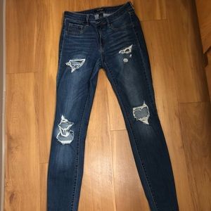 Stretchy dark washed distressed denim